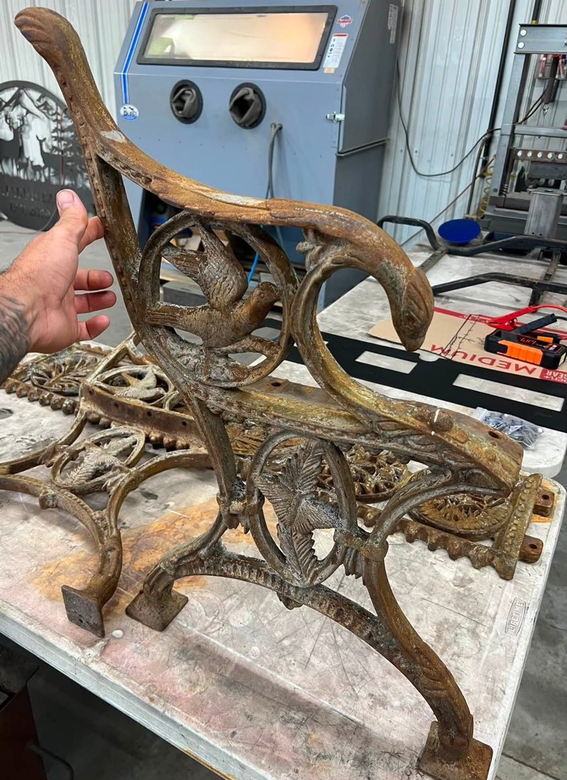 Rusted cast iron bench end before restoration