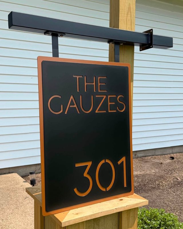 Custom 2 layer plasma cut address sign in black and copper on a custom bracket