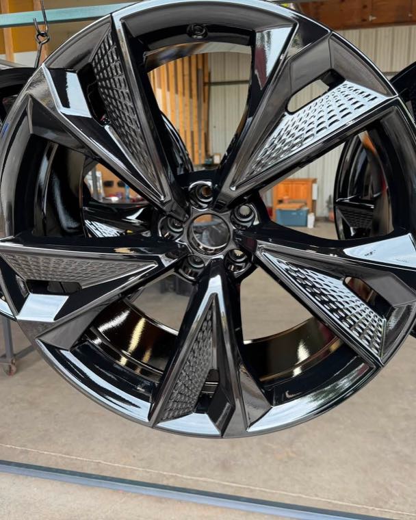 Four wheels on the rack after a gloss black powder coat finish