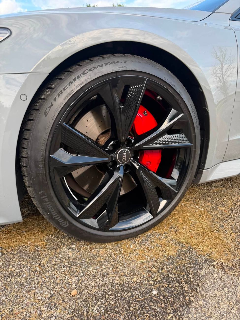 Gloss black powder coated wheel with red brake caliper on a 2022 Audi