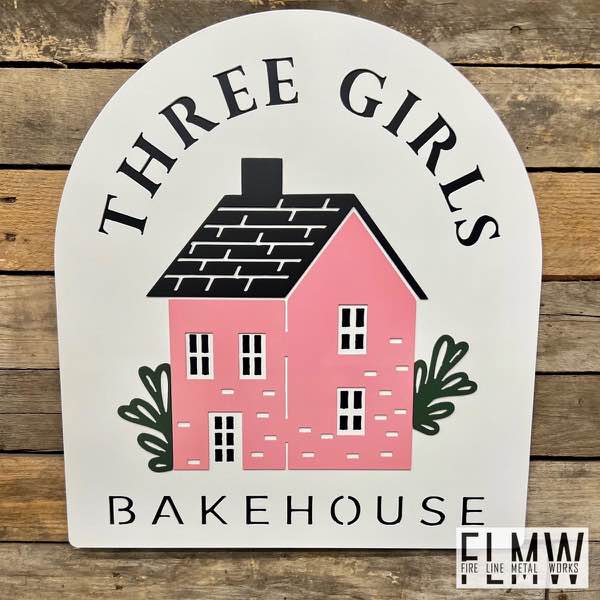 White, pink, and black plasma cut business sign for a bakehouse