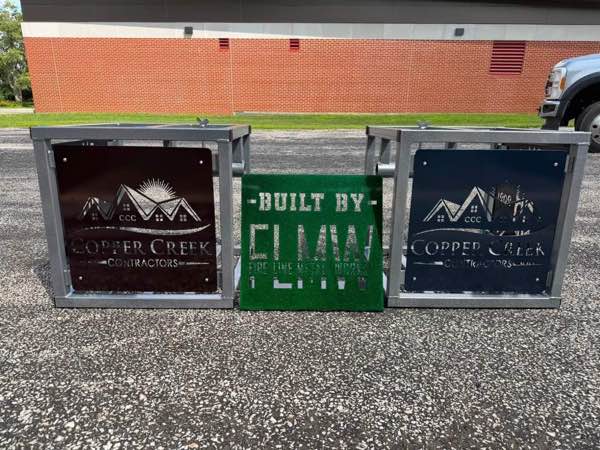 Two steel Silver Dollar Deadlift boxes with plasma cut sponsor panels and a Built by FLMW sign