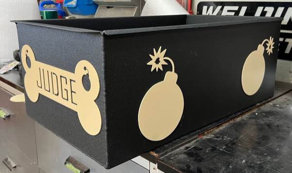 Black powder coated K9 travel box with plasma cut gold pieces