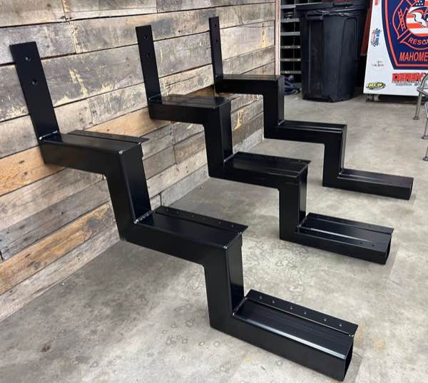 Three black powder coated custom steel stair risers